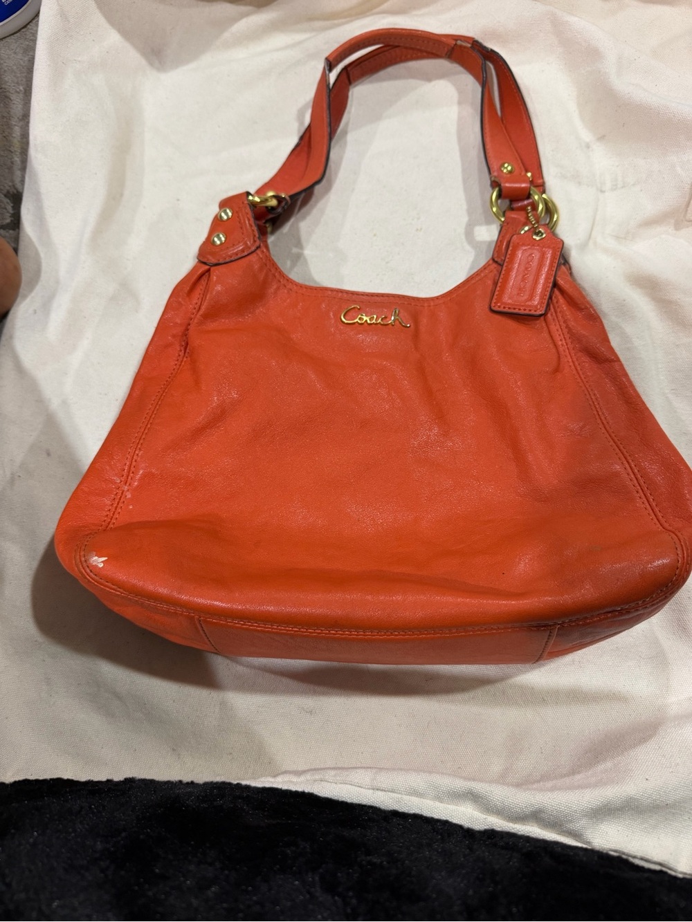 Coach Red-Orange Leather Shoulder Bag with Gold Hardware with assorted purse.
